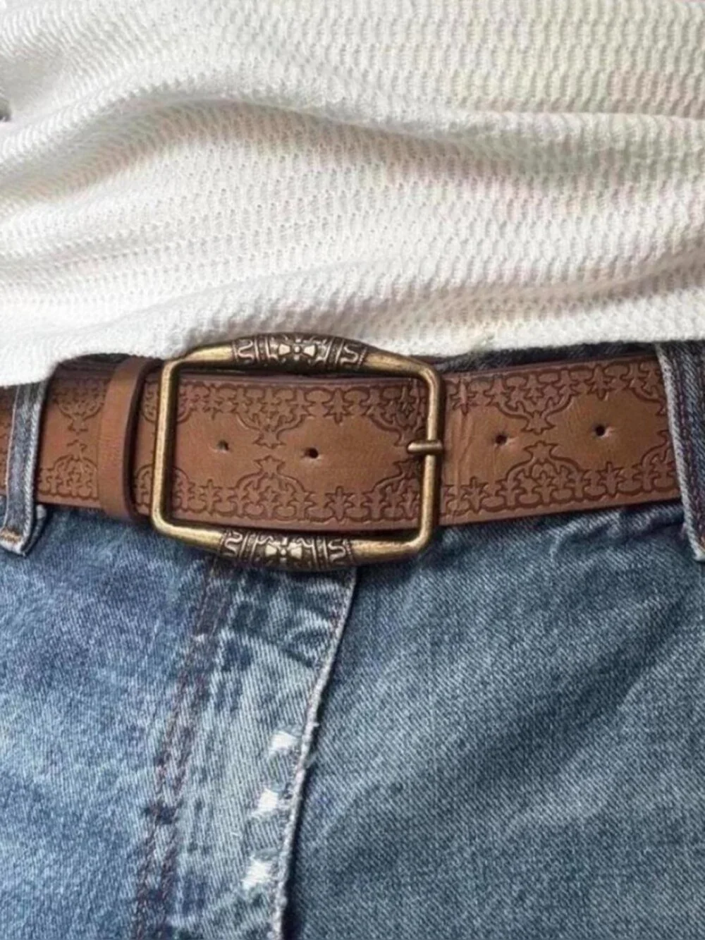 brown belt with embossed floral and scrollwork design
